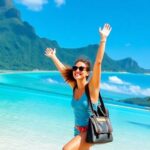 Traveler enjoying the beautiful Tahitian beach landscape.