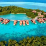 Luxury overwater bungalows in crystal-clear turquoise waters.