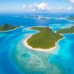 Aerial view of turquoise waters and lush islands.