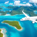 Aerial view of islands with turquoise lagoons and plane.