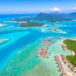 Aerial view of turquoise waters and lush islands.