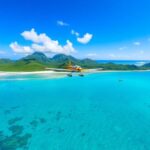 Lush green islands, clear blue water, small plane.