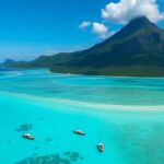 Turquoise lagoons surround lush volcanic islands.