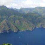 Lush green valleys and dramatic coastal cliffs of the Marquesas Islands.