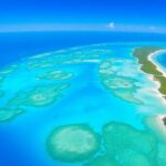 Tropical atoll islands, turquoise lagoons, and lush palm trees.