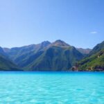 Turquoise lagoon waters meet lush green volcanic peaks.